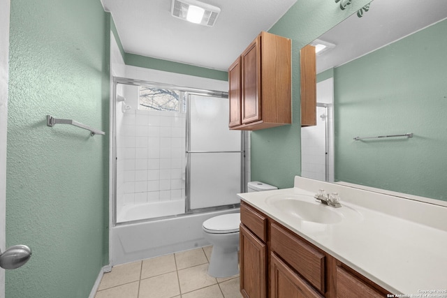 bathroom with a textured wall, tile patterned flooring, toilet, visible vents, and vanity