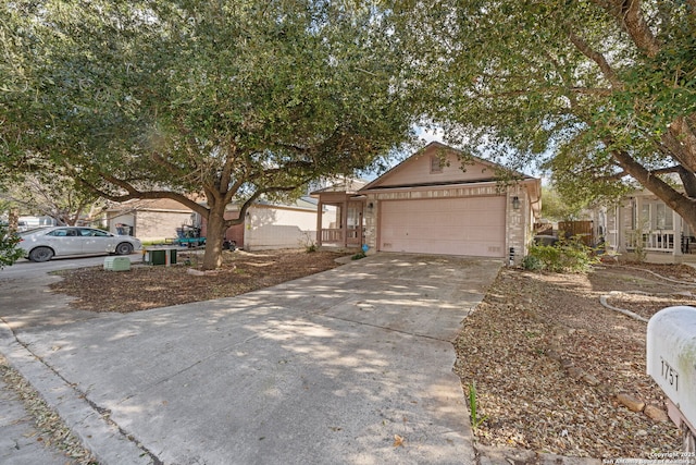 ranch-style home featuring a garage and concrete driveway