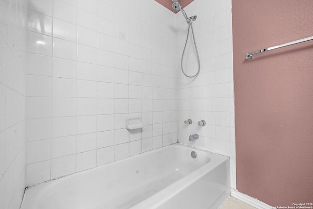 full bath with shower / bath combination, baseboards, and a textured wall