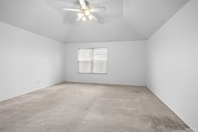 unfurnished room featuring a ceiling fan, carpet, vaulted ceiling, and baseboards