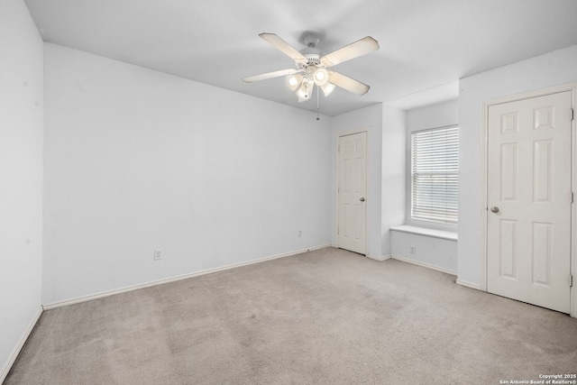 unfurnished bedroom with carpet flooring, a ceiling fan, and baseboards