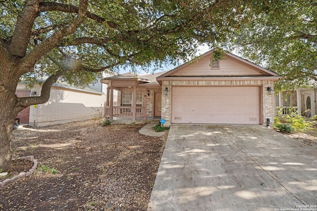 ranch-style house featuring a garage, concrete driveway, brick siding, and a porch