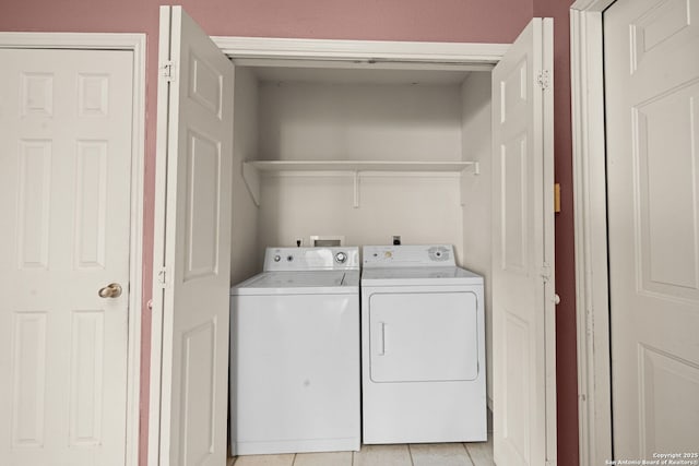 laundry area featuring light tile patterned floors, laundry area, and separate washer and dryer