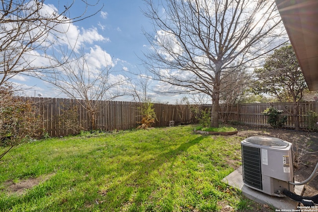 view of yard featuring central AC and a fenced backyard