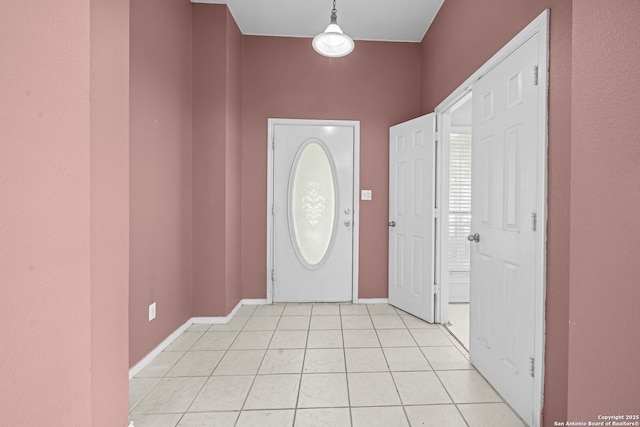 entrance foyer with light tile patterned floors and baseboards