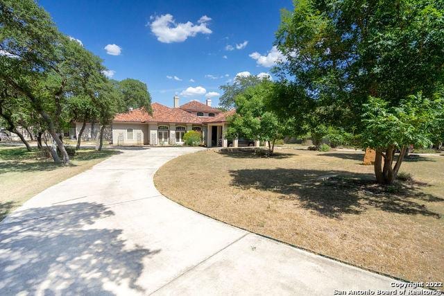 mediterranean / spanish house with driveway