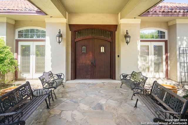 property entrance with stucco siding, a tiled roof, a patio area, and french doors