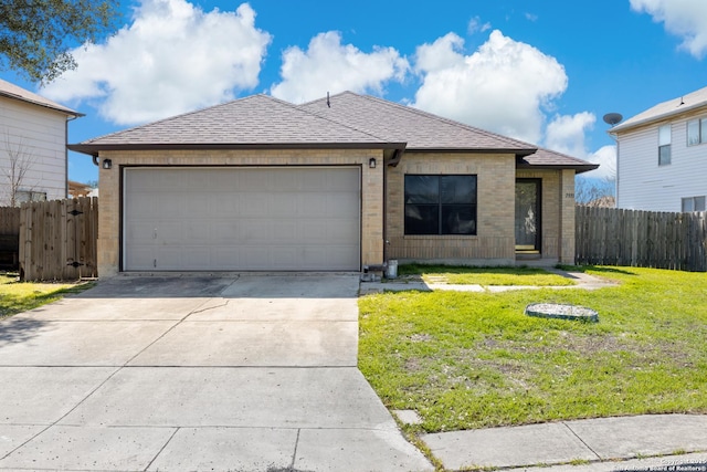 ranch-style house featuring an attached garage, a shingled roof, fence, concrete driveway, and a front yard