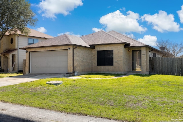 view of front of home featuring roof with shingles, concrete driveway, fence, a garage, and a front lawn