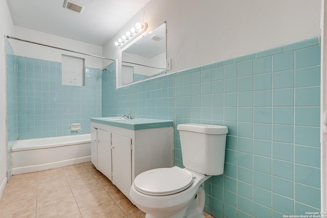 full bathroom featuring tile walls, bathtub / shower combination, visible vents, toilet, and tile patterned floors