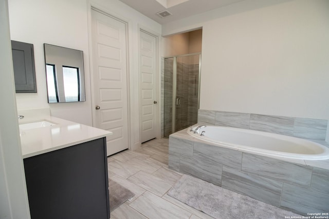 bathroom with visible vents, vanity, a shower stall, and a bath