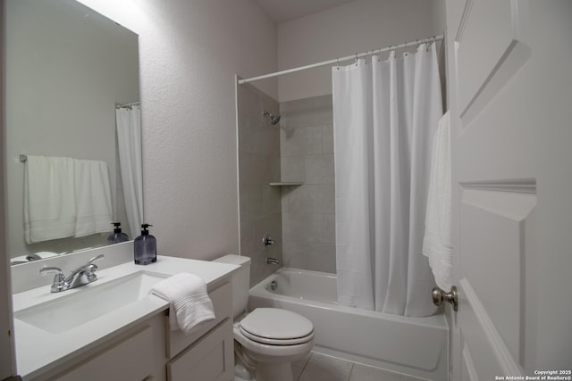 full bathroom with a textured wall, toilet, shower / bath combo with shower curtain, vanity, and tile patterned floors