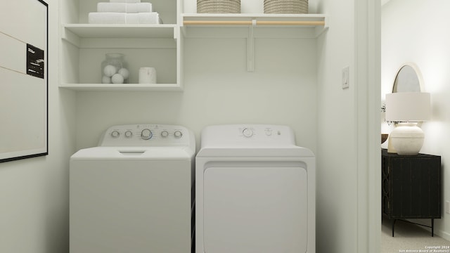 clothes washing area featuring laundry area and washer and clothes dryer