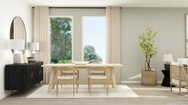 dining space with wood finished floors and baseboards