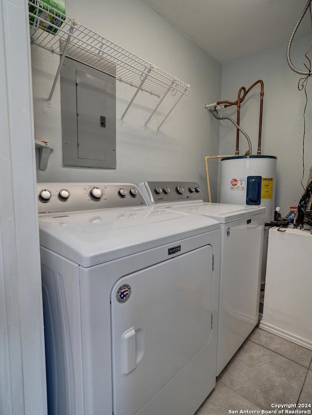 washroom with light tile patterned floors, laundry area, separate washer and dryer, water heater, and electric panel