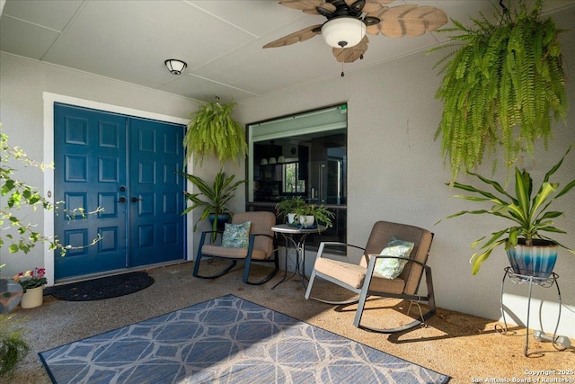 view of exterior entry with ceiling fan