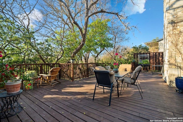 wooden terrace with outdoor dining space