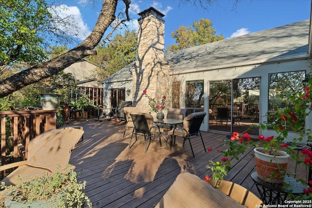 wooden terrace with outdoor dining space