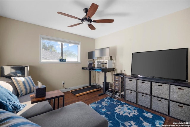 living room with ceiling fan, wood finished floors, and baseboards