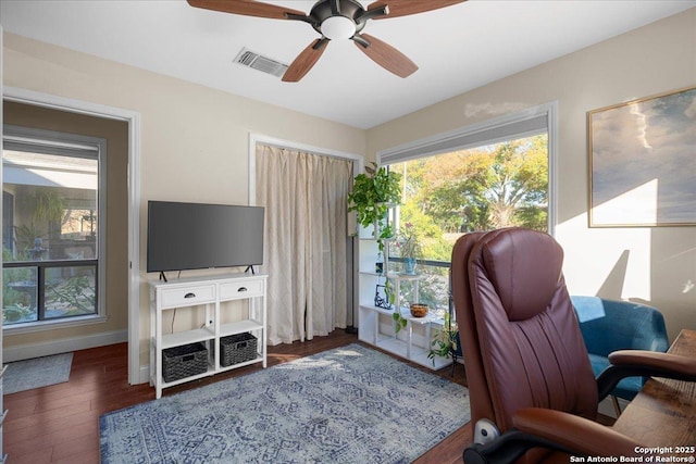 office area featuring visible vents, ceiling fan, baseboards, and wood finished floors