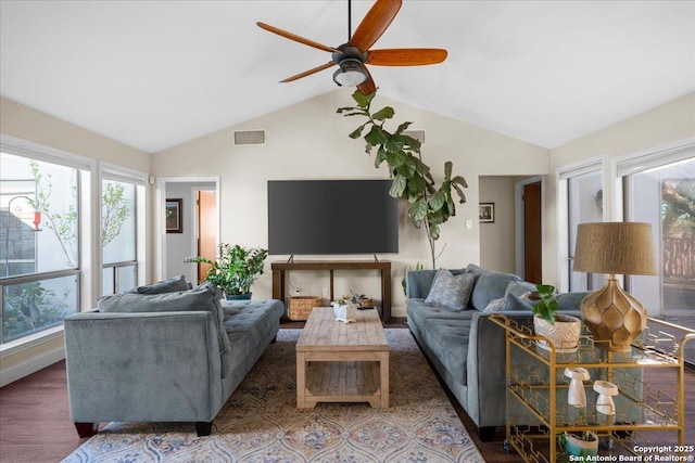 living room with visible vents, vaulted ceiling, a wealth of natural light, and wood finished floors