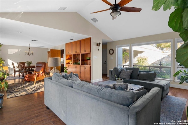 living area with high vaulted ceiling, dark wood-style flooring, visible vents, and ceiling fan with notable chandelier