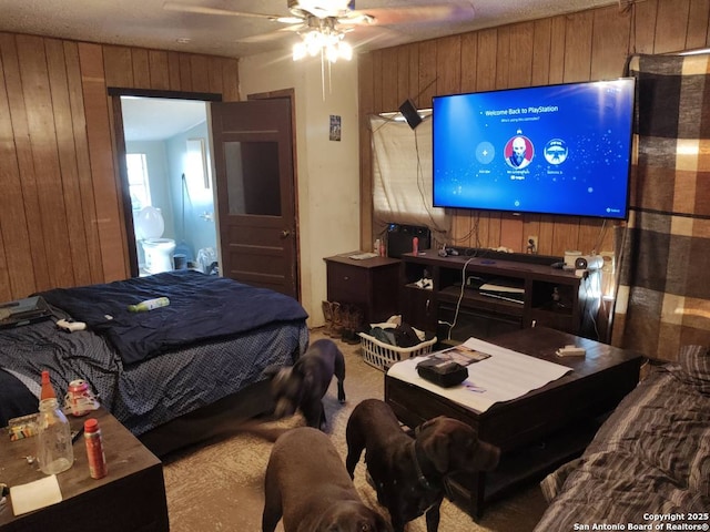 bedroom featuring a ceiling fan and wooden walls