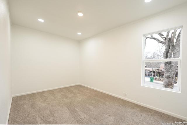 spare room with ornamental molding, recessed lighting, carpet flooring, and baseboards