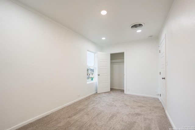 unfurnished bedroom with carpet floors, recessed lighting, a closet, visible vents, and baseboards