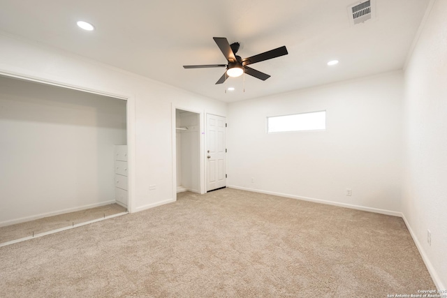 unfurnished bedroom featuring light carpet, recessed lighting, visible vents, and baseboards