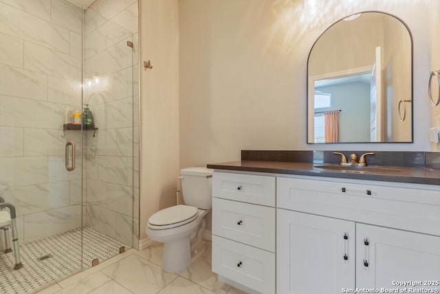 bathroom featuring marble finish floor, vanity, a shower stall, and toilet