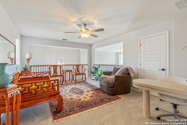 living area with ceiling fan, carpet floors, and visible vents