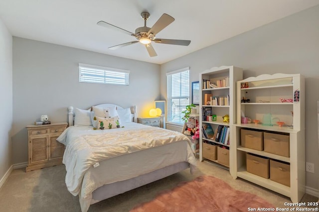 bedroom with baseboards, a ceiling fan, and light colored carpet