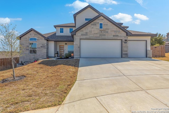 view of front facade featuring concrete driveway, stone siding, an attached garage, fence, and a front lawn