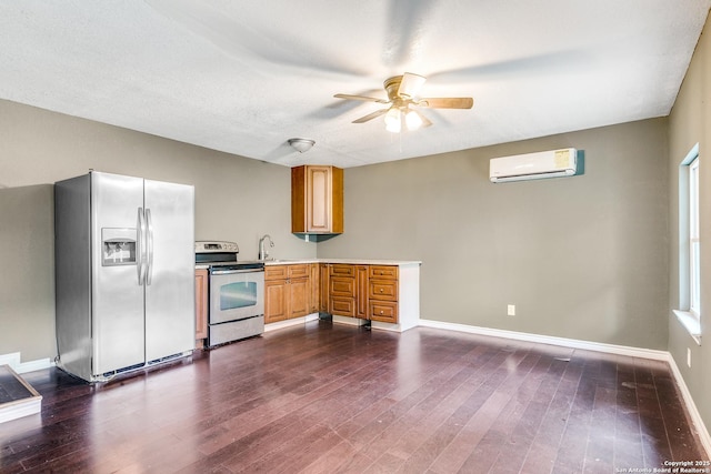 kitchen with dark wood finished floors, stainless steel appliances, light countertops, and a wall mounted air conditioner