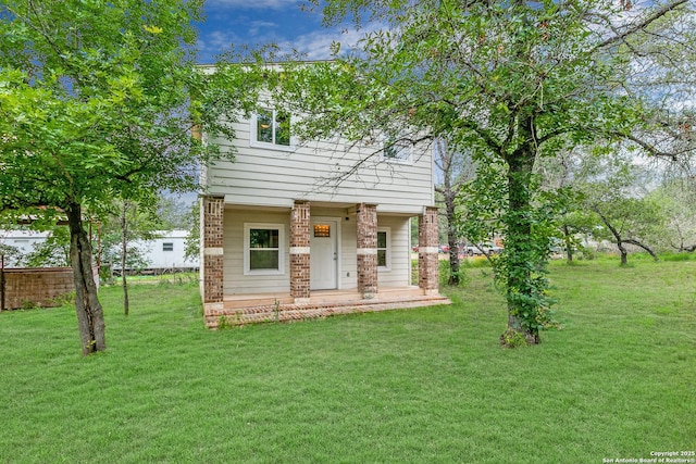 view of front of house featuring a front yard and brick siding