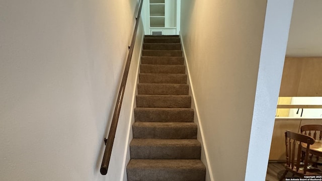 stairway with visible vents and baseboards