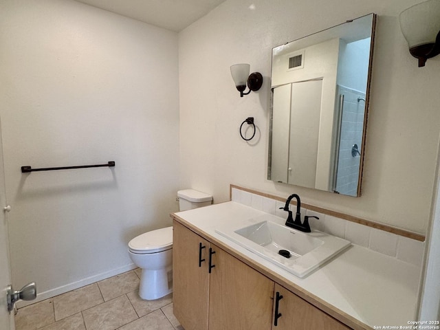 bathroom with toilet, vanity, visible vents, and tile patterned floors