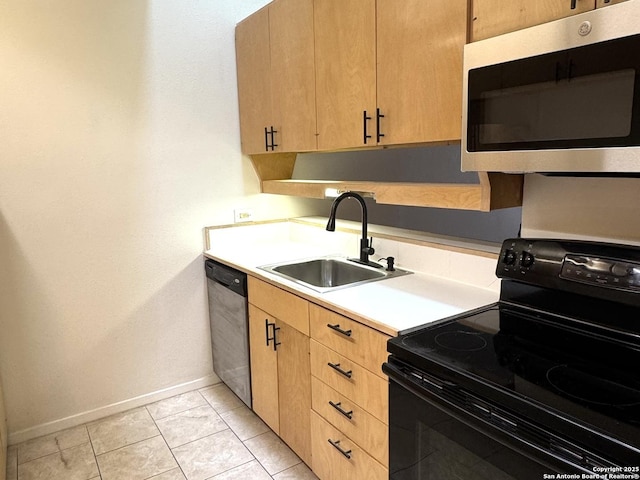 kitchen with light countertops, light brown cabinetry, appliances with stainless steel finishes, light tile patterned flooring, and a sink