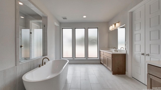 417 Verdad Way, Boerne, TX 78006 - bathroom with a freestanding bath, vanity, a stall shower, recessed lighting, and tile patterned floors