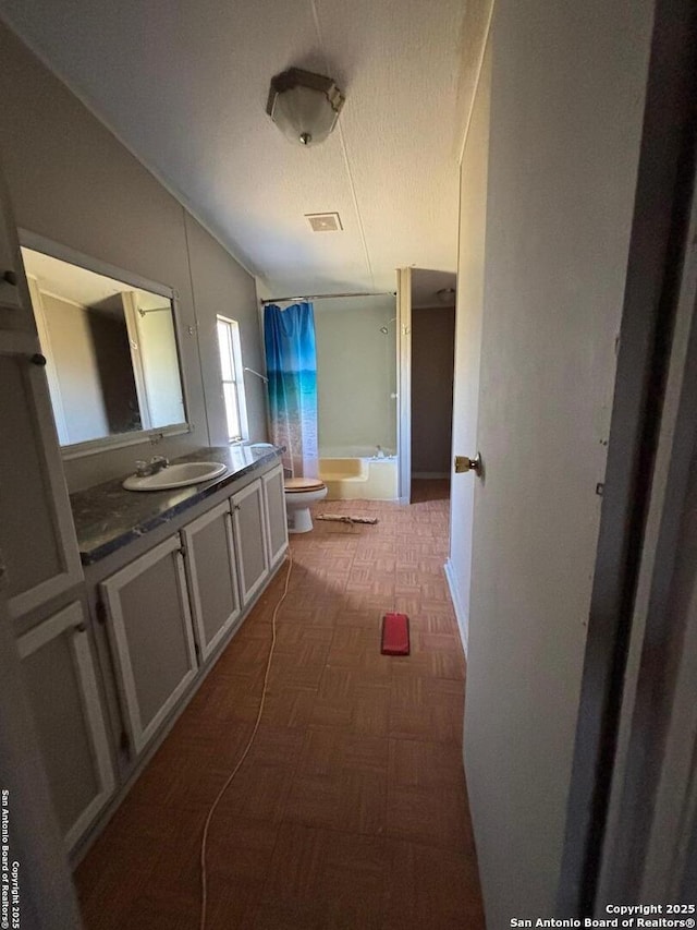 full bath with curtained shower, a washtub, toilet, vanity, and vaulted ceiling