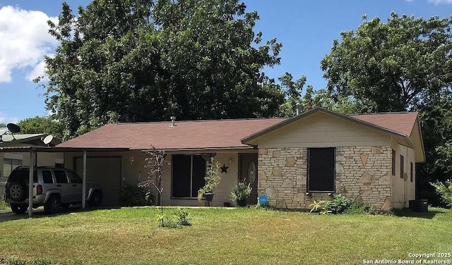 ranch-style house featuring an attached garage, stone siding, and a front yard