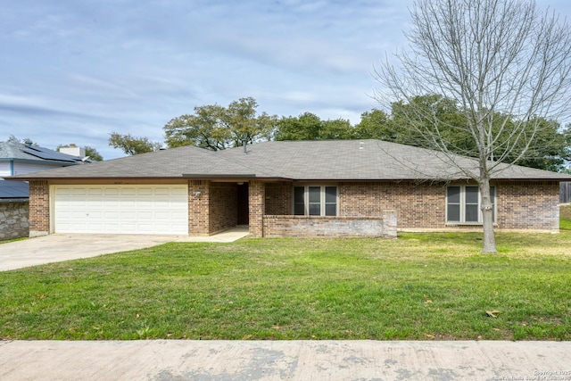 single story home featuring concrete driveway, brick siding, an attached garage, and a front lawn