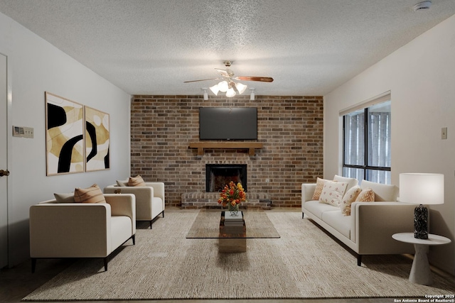 living room with a ceiling fan, a fireplace, and a textured ceiling