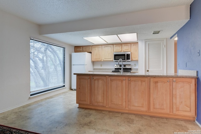 kitchen with visible vents, appliances with stainless steel finishes, concrete flooring, a textured ceiling, and light brown cabinets