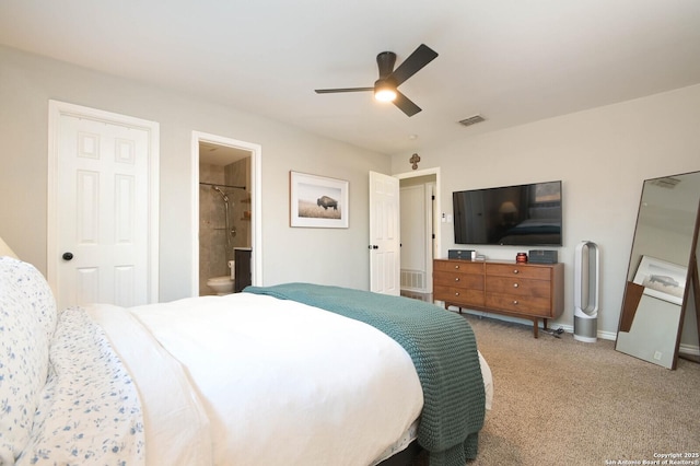 carpeted bedroom with visible vents, ceiling fan, baseboards, and ensuite bathroom