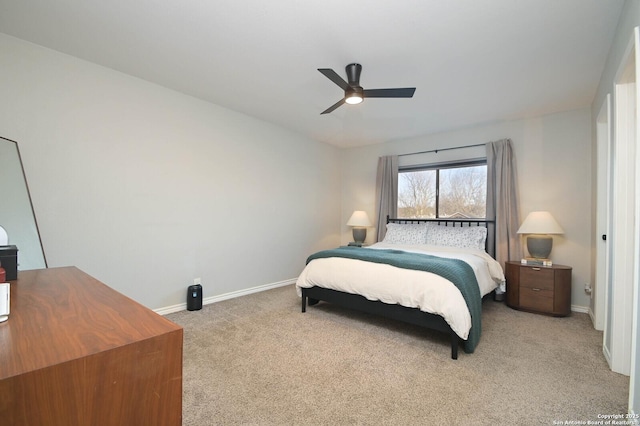 bedroom featuring baseboards, a ceiling fan, and light colored carpet