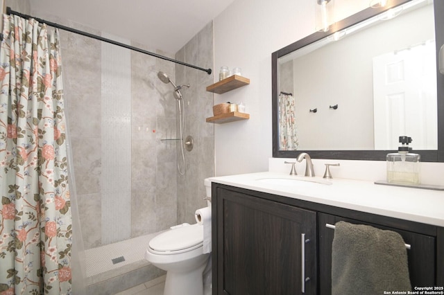 full bath with toilet, a tile shower, and vanity