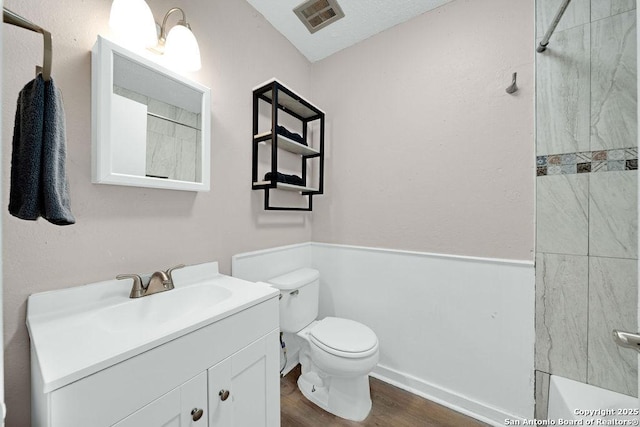 full bathroom featuring toilet, wood finished floors, visible vents, vanity, and a shower