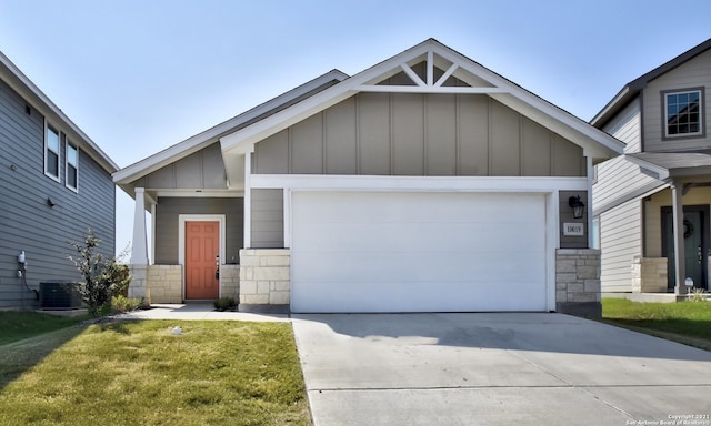 craftsman house featuring central air condition unit, a garage, board and batten siding, and concrete driveway